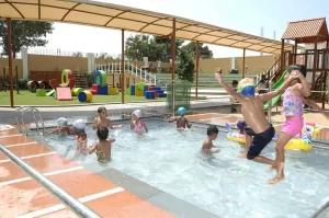a group of kids playing in a pool