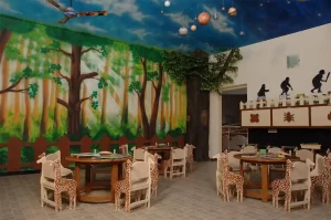 a room with a painted wall and a table and chairs